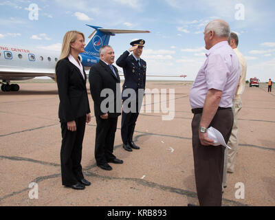 At the airport in Baikonur, Kazakhstan, Expedition 36/37 Flight Engineer Karen Nyberg of NASA (left) Soyuz Commander Fyodor Yurchikhin (center) and Flight Engineer Luca Parmitano of the European Space Agency (right) are greeted by Russian space officials May 16 as they arrived at the launch site for final preparations for their launch May 29, Kazakh time, in their Soyuz TMA-09M spacecraft to begin a 5 ½ month mission on the International Space Station.  NASA/Victor Zelentsov Soyuz TMA-09M crew at the airport in Baikonur Stock Photo