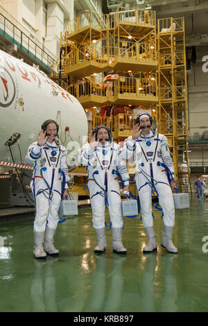 In the Integration Facility at the Baikonur Cosmodrome in Kazakhstan, Expedition 36/37 Flight Engineer Karen Nyberg of NASA (left), Soyuz Commander Fyodor Yurchikhin (center) and Flight Engineer Luca Parmitano of the European Space Agency (right) pose for pictures during a suited dress rehearsal “fit check” exercise May 17. The trio will launch May 29, Kazakh time, in their Soyuz TMA-09M spacecraft to begin a 5 ½ month mission on the International Space Station.  NASA/Victor Zelentsov Soyuz TMA-09M crew during the 'fit check' Stock Photo