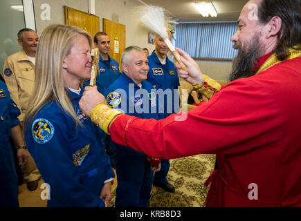 Expedition 36/37 Flight Engineer Karen Nyberg of NASA, left, Soyuz Commander Fyodor Yurchikhin of the Russian Federal Space Agency (Roscosmos), center, and Flight Engineer Luca Parmitano of the European Space Agency, receive a traditional blessing from an Orthodox Priest prior to the three crew members departing the Cosmonaut Hotel for suit up and launch onboard a Soyuz to the International Space Station, Tuesday, May 28, 2013, Baikonur Kazakhstan. The crew's Soyuz rocket is scheduled to launch at 2:31a.m., Wednesday May 29, Kazakh time. Yurchikhin, Nyberg, and, Parmitano, will remain aboard t Stock Photo