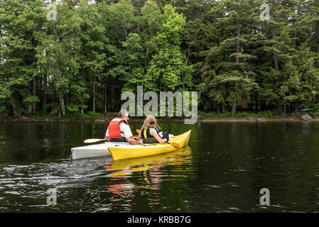 family kayaking on Flying Pond, Mount Vernon, Maine Stock Photo