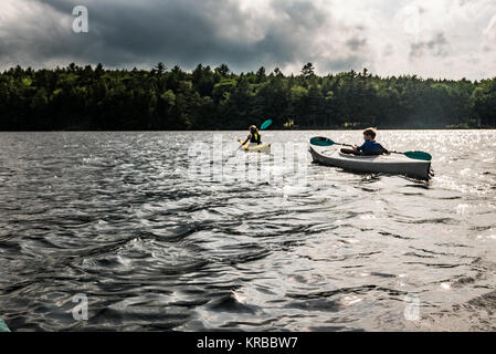 family kayaking on Flying Pond, Mount Vernon, Maine Stock Photo