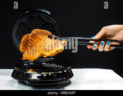 Person making fresh waffles Stock Photo