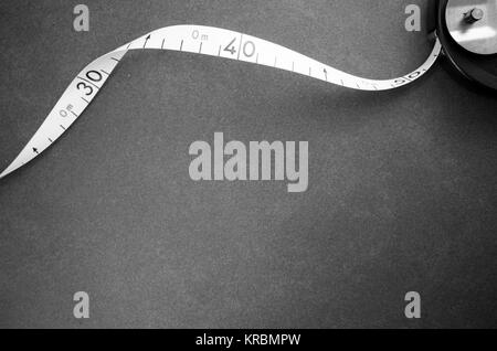 industrial metric measuring tape on a stone surface - top view Stock Photo