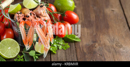 Raw langoustine in a bucket and vegetables Stock Photo