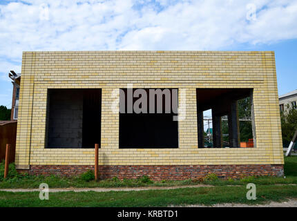 House under construction from yellow bricks Stock Photo