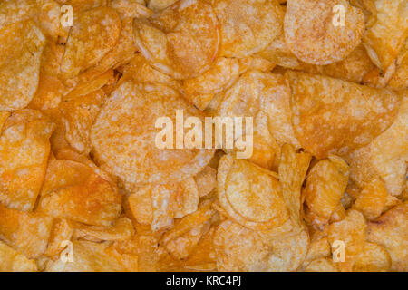 Many potato chips as a texture background. Stock Photo