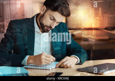 Charming businessman writing in his daily planner Stock Photo