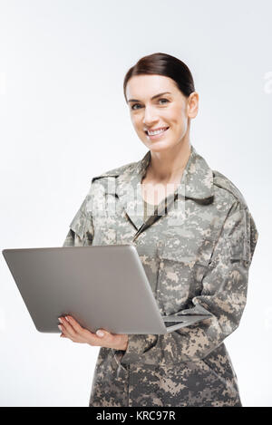 Young female soldier working with laptop in headquarters building Stock ...