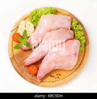 Raw hare game meat, legs and offals in wooden plate with herb. Isolated ...