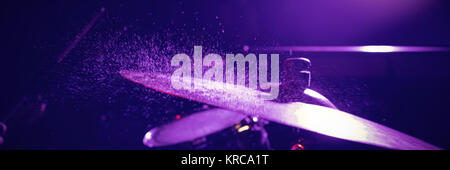 Close up of wet drum set in illuminated nightclub Stock Photo