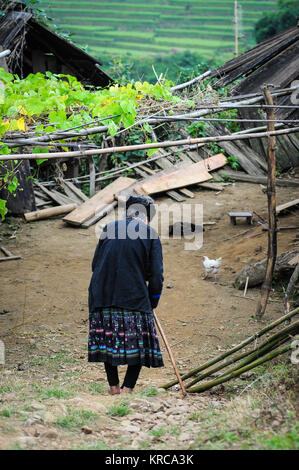 An old woman walking on road in Yen Bai, Northern Vietnam. Stock Photo