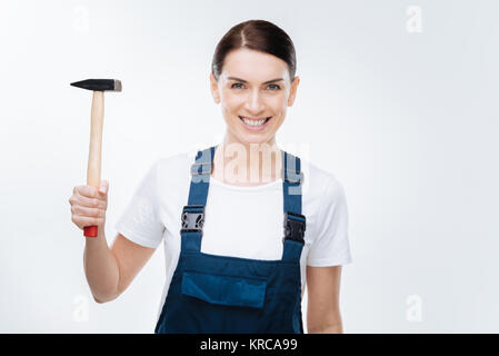 Cheerful  female worker operating with hammer Stock Photo