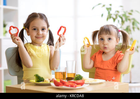 happy children eating healthy food in kindergarten or at home Stock Photo