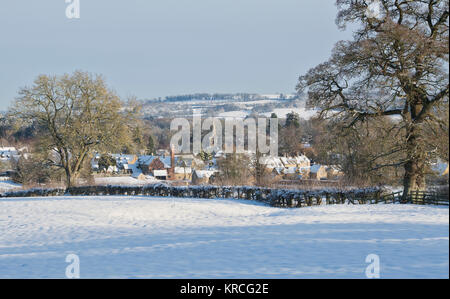 Lower Slaughter village in the snow with blue sky in December. Lower Slaughter, Cotswolds, Gloucestershire, England. Stock Photo