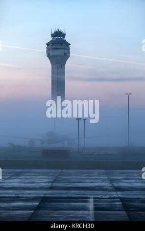 Dulles airport control tower, a single airplane, no people visible, a foggy early morning pink and blue sky. Loudoun & Fairfax county, Virginia, USA. Stock Photo