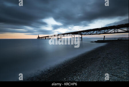 Seascape with jetty during a dramatic cloudy sunset  at Xeros area in Northern Cyprus