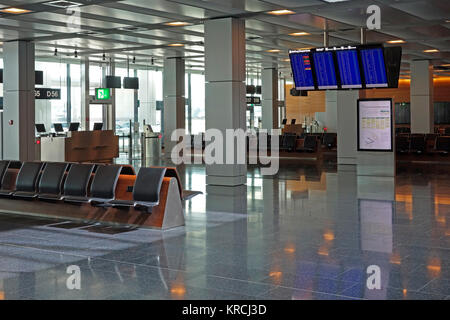 Empty airport departure lounge waiting area with flight information screens. Stock Photo