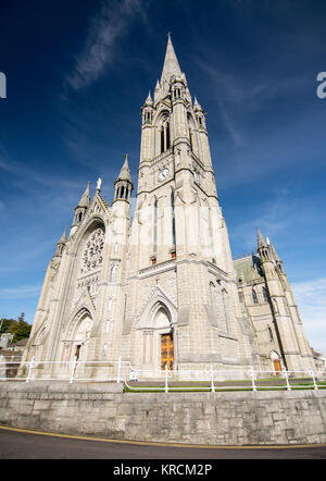 Cork, Ireland - September 15, 2016: Afternoon sun lights the exterior of St Colman's Cathedral in the small tourist city of Cobh on the south coast of Stock Photo