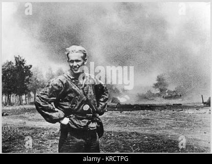 A well known scene from the German newsreel 'Deutsche Wochenschau', No. 672 from 21th July 1943. The scene shows the German soldier Rudolf Nadler, member of the 1st SS Division 'Leibstandarte Adolf Hitler' who had knocked out several Soviet tanks in close combat on 10th July 1943, during the Battle of Kursk. The scene shows Nadler in front of the burning tanks (in the background). Date: 1943 Stock Photo