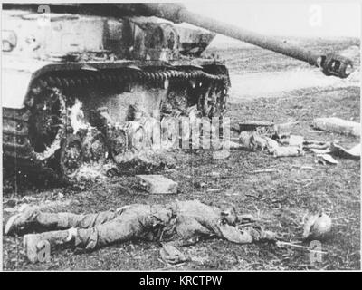 A German 'Tiger' tank is put out of action by the Russians : the bodies of its crew, and their belongings, lie strewn on the ground. Stock Photo