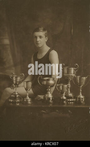 Fourteen year old swimming champion with trophies Stock Photo