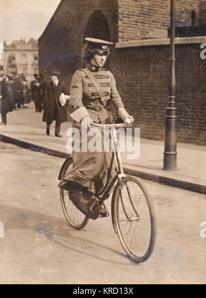 A woman cyclist first aid scout of the First Aid Nursing Yeomanry (FANY), riding along in her distinctive uniform.  The FANY was created in 1907 as a first aid link between front-line fighting units and field hospitals.  During the First World War FANY members ran field hospitals, drove ambulances and set up soup kitchens and troop canteens, often under dangerous conditions.  By the time of the Armistice in November 1918 they had been awarded many decorations for bravery, including 17 Military Medals, 1 Legion d'Honneur and 27 Croix de Guerre.  They also served during the Second World War, and Stock Photo