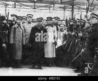 Sun Yat Sen (1866-1925) (at the centre in a fur coat) leaving Shanghai for Nanking to assume his position as President of the newly formed Republic of China, surrounded by his advisory military staff.  Sun played an instrumental role in overthrowing the Qing Dynasty in October 1911, the last imperial dynasty of China. He was the first provisional president when the Republic of China (ROC) was founded in 1912.       Date: circa 1911 Stock Photo