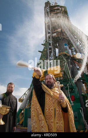 An Orthodox priest blesses members of the public at the the Baikonur Cosmodrome Soyuz launch pad on Tuesday, Sept. 24, 2013 in Baikonur, Kazakhstan.  Launch of the Soyuz rocket is scheduled for September 26 and will send Expedition 37/38 Flight Engineer Michael Hopkins of NASA, Soyuz Commander Oleg Kotov and Flight Engineer and Russian Flight Engineer Sergei Ryazansky on a five-month mission aboard the International Space Station.  Photo Credit: (NASA/Victor Zelentsov) Soyuz TMA-10M rocket blessing (2) Stock Photo