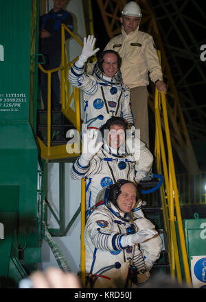 Expedition 37 Russian Flight Engineer Sergey Ryazanskiy, top, NASA Flight Engineer Michael Hopkins, Soyuz Commander Oleg Kotov, bottom, wave farewell from the base of the Soyuz rocket at the Baikonur Cosmodrome in Baikonur, Kazakhstan, Thursday, Sept. 26, 2013.  Their Soyuz TMA-10M rocket is scheduled to launch at 2:58 a.m. local time.  Photo Credit: (NASA/Carla Cioffi) Soyuz TMA-10M crew members wave farewell Stock Photo