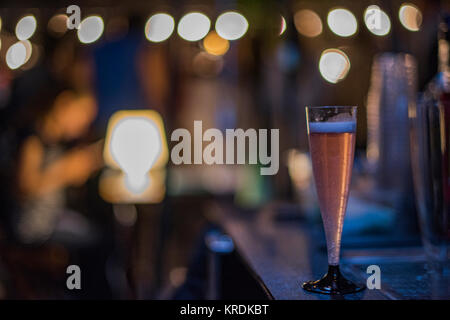 Closeup of a glass with pink drink at night Stock Photo