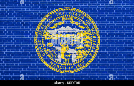 Flag of Nebraska on brick wall texture background Stock Photo