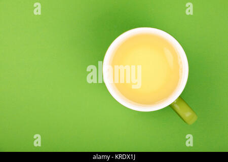 One full big cup of green oolong tea with saucer Stock Photo