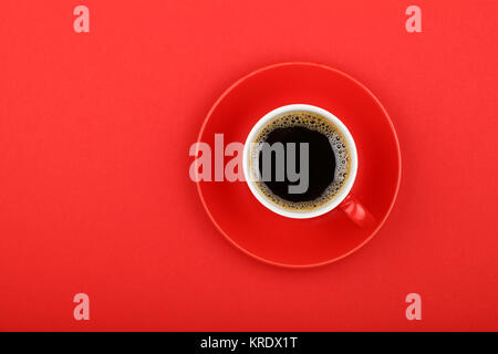 Americano coffee in full cup with saucer on red Stock Photo