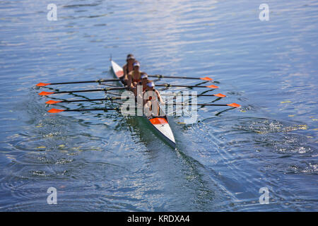 Team of rowing Four-oar women in boat Stock Photo