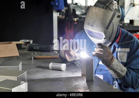 welder works in a metal construction company Stock Photo