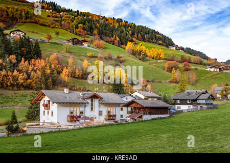 Rural homes and pastures with fall foliage color near Funes, Italy, Europe. Stock Photo