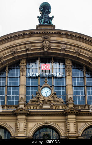Frankfurt Main railway station,Hauptbahnhof eastern façade with clock & two symbolic statues for day and night & and Deutsche Bahn. Roof has statue of