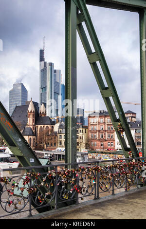 Frankfurt, Germany,Eiserner Steg iron foot bridge across the Main river covered in Love locks View of old & new buildings,modern & historic Stock Photo