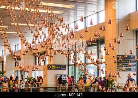 Singapore - September 24, 2017: Visitors walk around Departure Hall in Changi Airport. It has 3 passenger terminals, and is one of the largest transpo Stock Photo