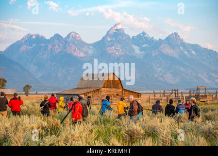 Group of photographers set up cameras in front of John Moulton Barn and Teton Mountain Range, Grand Tetons National Park, Teton County, Wyoming Stock Photo