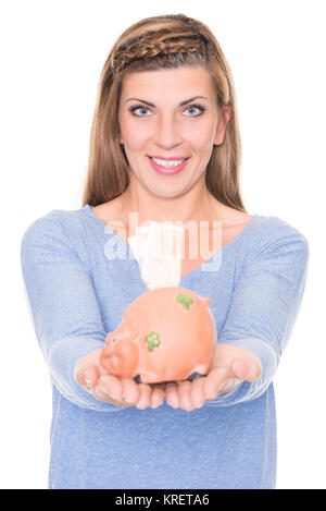 Porträt einer jungen Frau mit Sparschwein vor weißem Hintergrund Stock Photo