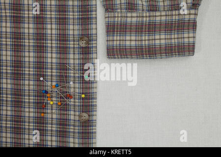 checkered shirt and pins on a tailor's table, copy space Stock Photo