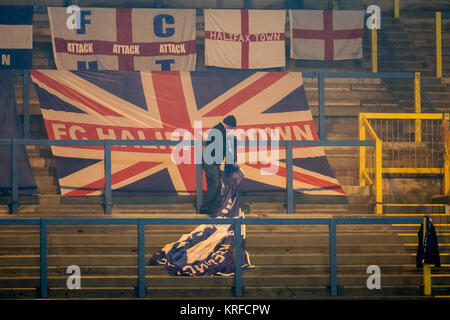 Halifax, West Yorkshire, UK. 19th Dec, 2017. An FC Halifax Town supporter starts to put the club flags away after the referee calls the FA Trophy game off minutes before kick off due to a partially frozen pitch. FC Halifax Town v Macclesfield Town in the first round of the FA Trophy on Tuesday 19 December 2017 at The Shay, Halifax, West Yorkshire. Photo by Mark P Doherty. Credit: Caught Light Photography Limited/Alamy Live News Stock Photo