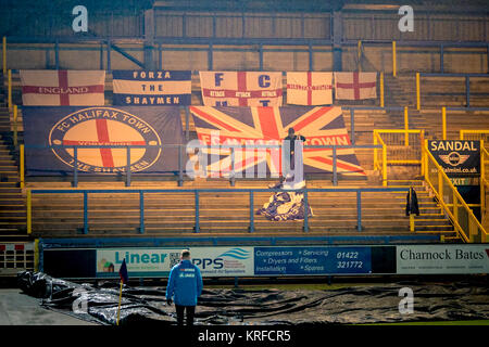 Halifax, West Yorkshire, UK. 19th Dec, 2017. An FC Halifax Town supporter starts to put the club flags away after the referee calls the FA Trophy game off minutes before kick off due to a partially frozen pitch. FC Halifax Town v Macclesfield Town in the first round of the FA Trophy on Tuesday 19 December 2017 at The Shay, Halifax, West Yorkshire. Photo by Mark P Doherty. Credit: Caught Light Photography Limited/Alamy Live News Stock Photo