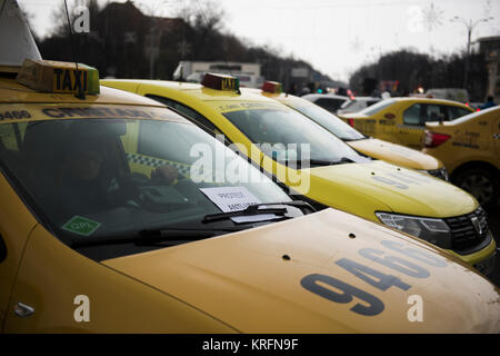 Bucharest, Romania  - December 20, 2017: Romanian taxi drivers protest in front of the government headquarters against Uber and other apps that steal their clients. Stock Photo