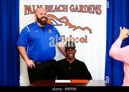 Florida, USA. 20th Dec, 2017. Gurvan Hall, signing for the University of Miami, celebrates with head coach Billy Clark at Palm Beach Gardens High School on December 20, 2017. Credit: Richard Graulich/The Palm Beach Post/ZUMA Wire/Alamy Live News Stock Photo
