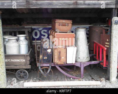 Old suitcases and milk churns on Victorian trolleys at the Didcot Railway Museum, Oxfordshire. Stock Photo