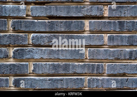 Old wall of dark gray stone bricks Stock Photo
