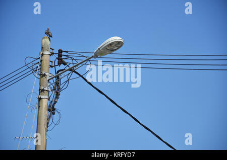 Lamp post with many cables Stock Photo