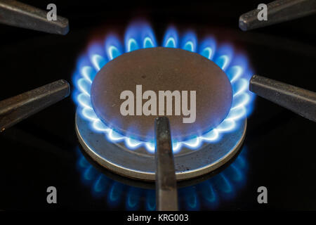 Blue natural gas flame on a domestic cooker gas hob Stock Photo